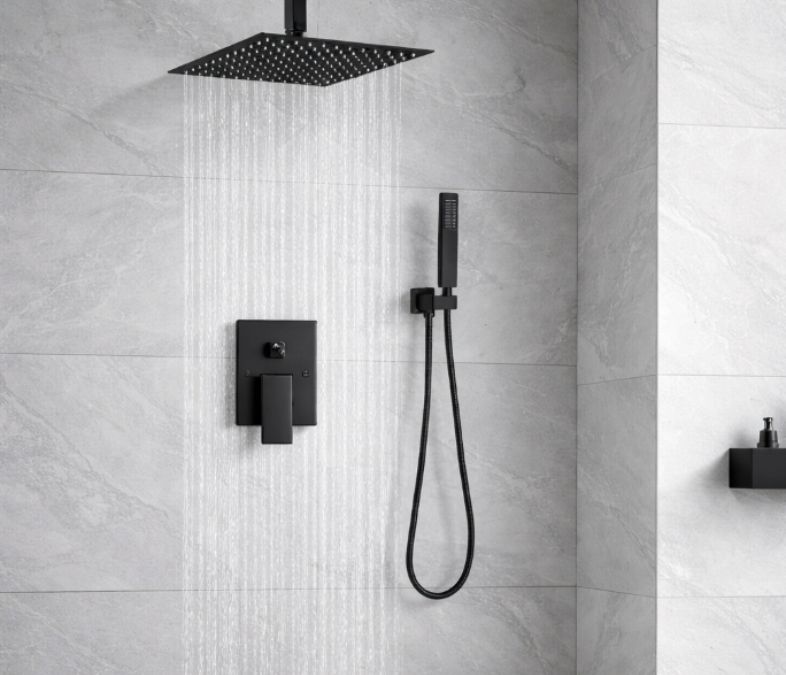 Installed shower system – Matte black ceiling rain shower system installed in a modern bathroom with handheld sprayer and wall controls.